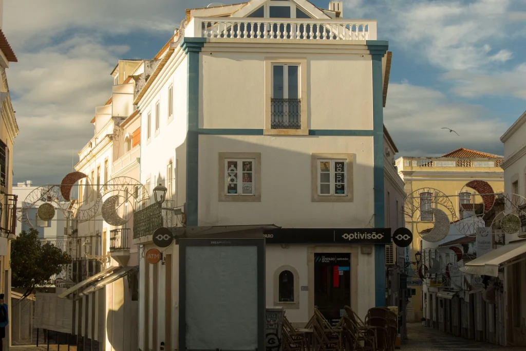 Historic buildings and outdoor café seating on a street in Lagos Old Town